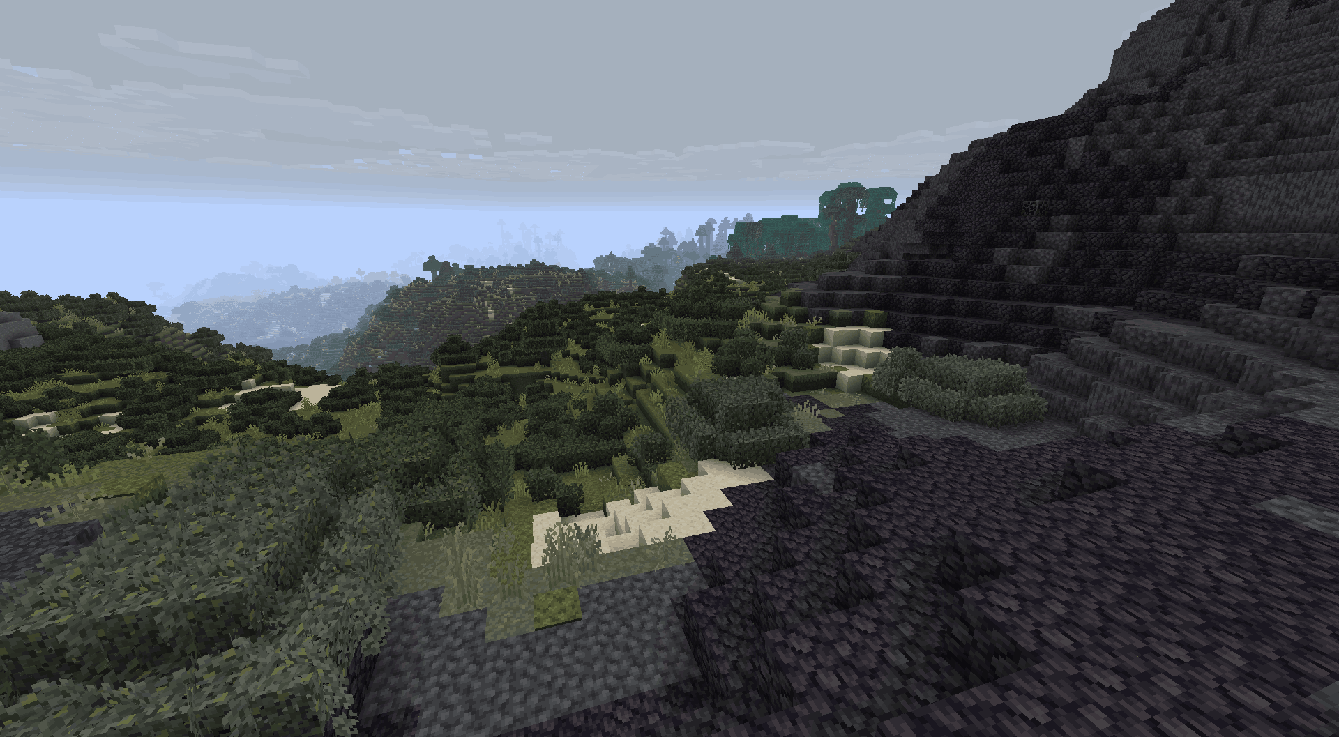 Thumbnail A mass of black rock towers against the gray sky, surrounded by sands and green hills. It is a natural boundary, a threshold separating the known from the forbidden. ⛰️🌫️
