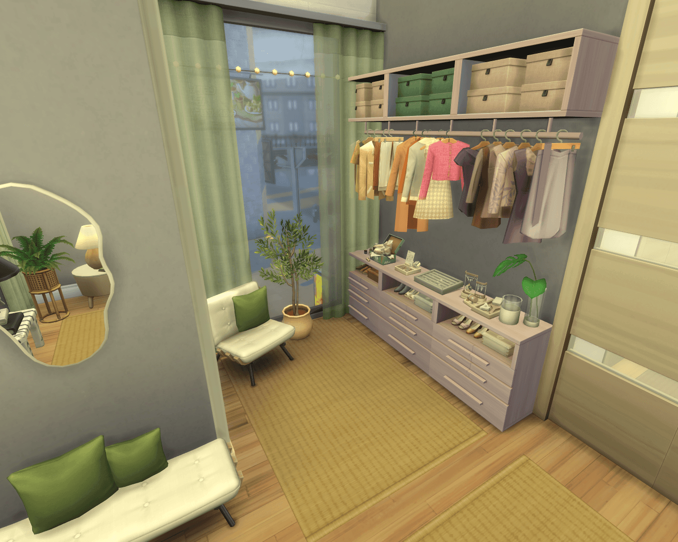 overview of the wardrobe area with hanging clothes, jewellery, shoes, shoes & bags boxes, a wall mirror and armchair!