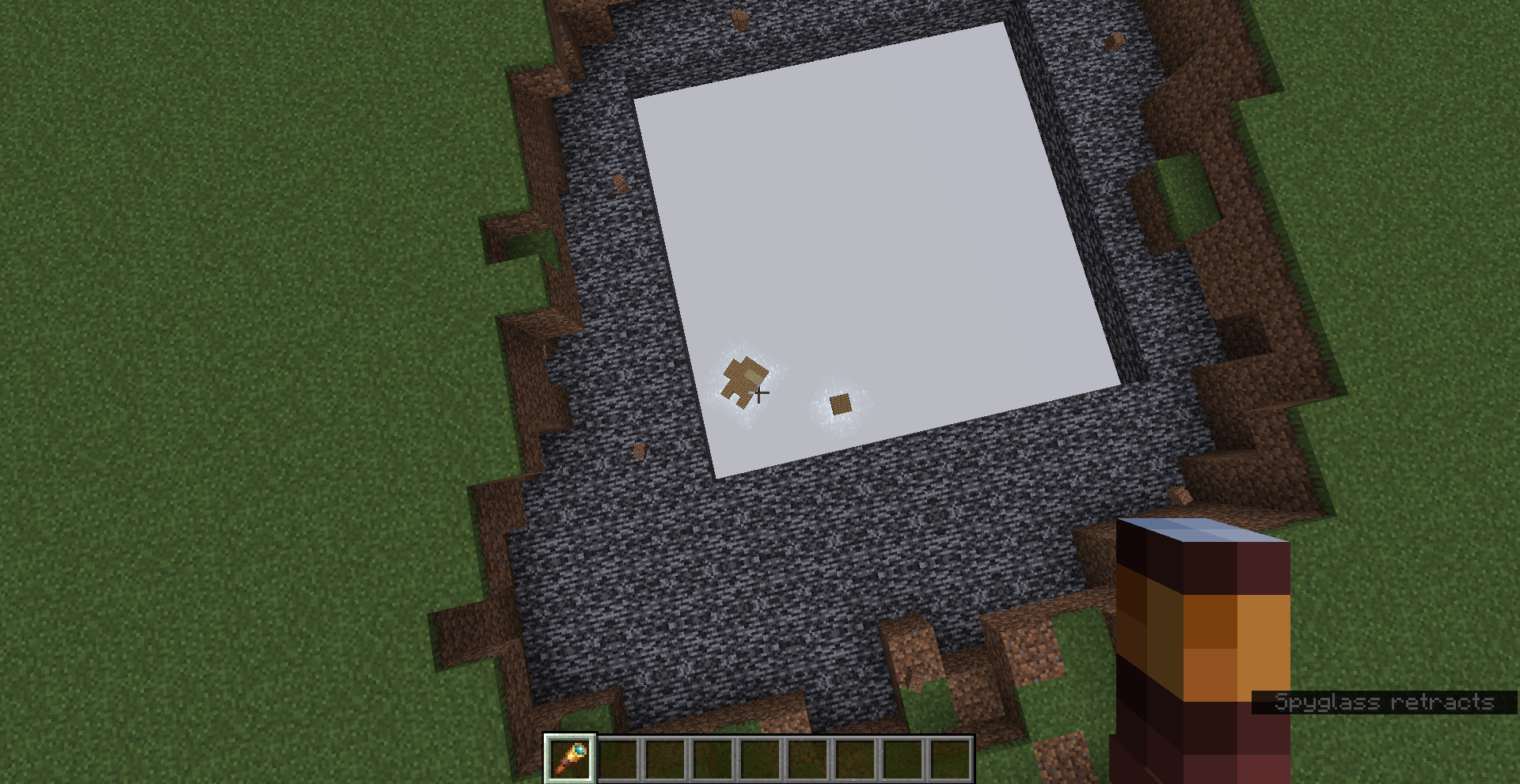 far shot showing a superflat world with a hole in the bedrock. beneath the bedrock is shown two physics objects floating on the Overworld Void sea.