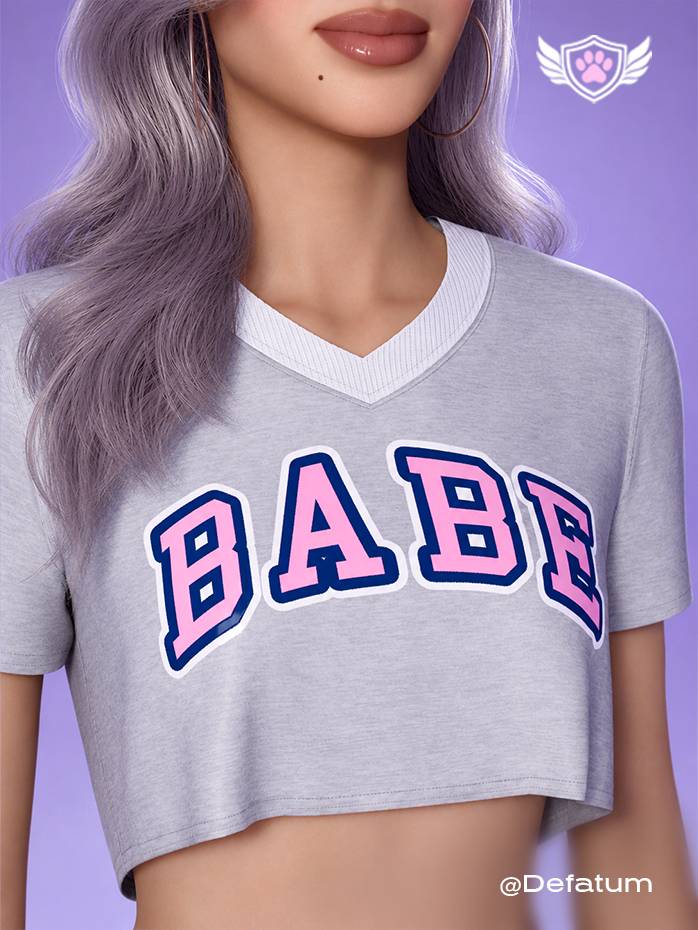 The Campus Sweetheart crop top from the College Core Collection 25’. Close-up view highlighting the pink “BABE” varsity lettering and white V-neck trim.