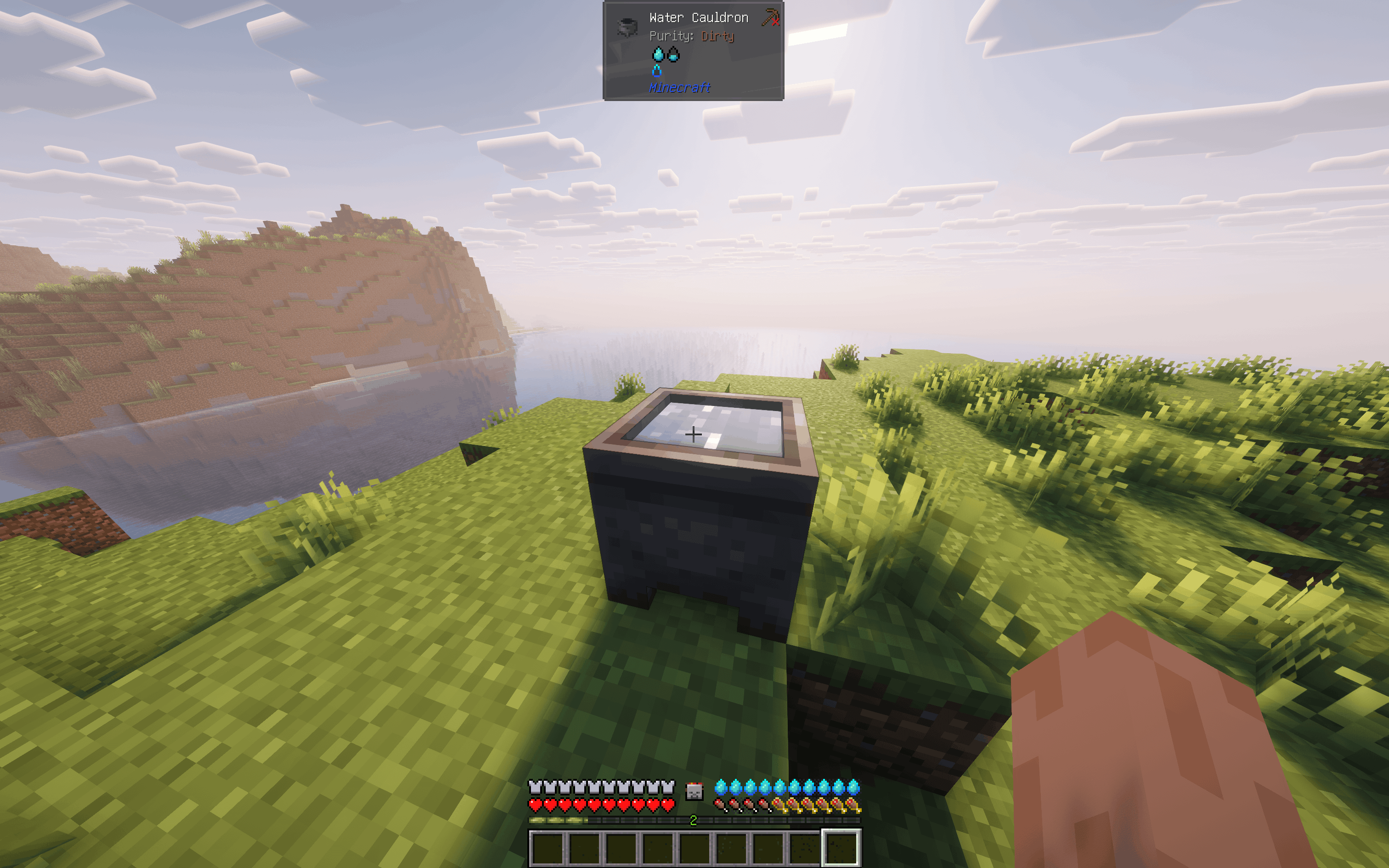 A screenshot showing Jade's in-world tooltip overlay displaying the purity level (e.g. "Purity: Purified") when the player looks at a water block or cauldron.