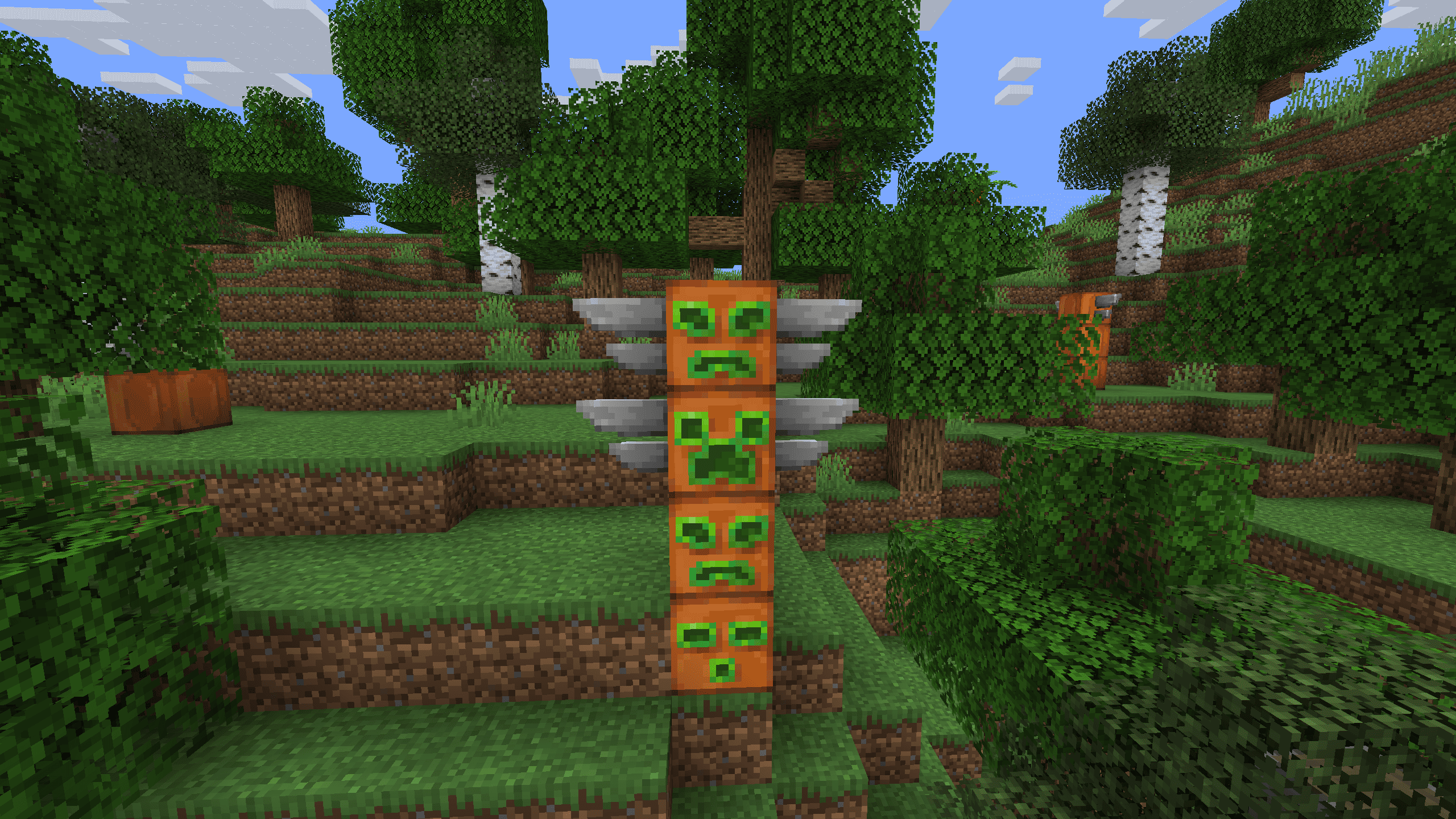 Thumbnail A mysterious totem pole featuring a Creeper face with decorative wings attached to the sides.