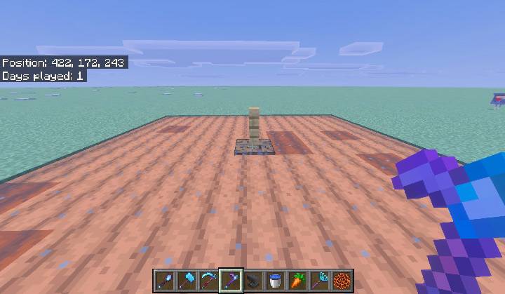 A finished 9 by 9 farmland field with a waterlogged block at the centre and a fence post standing on it