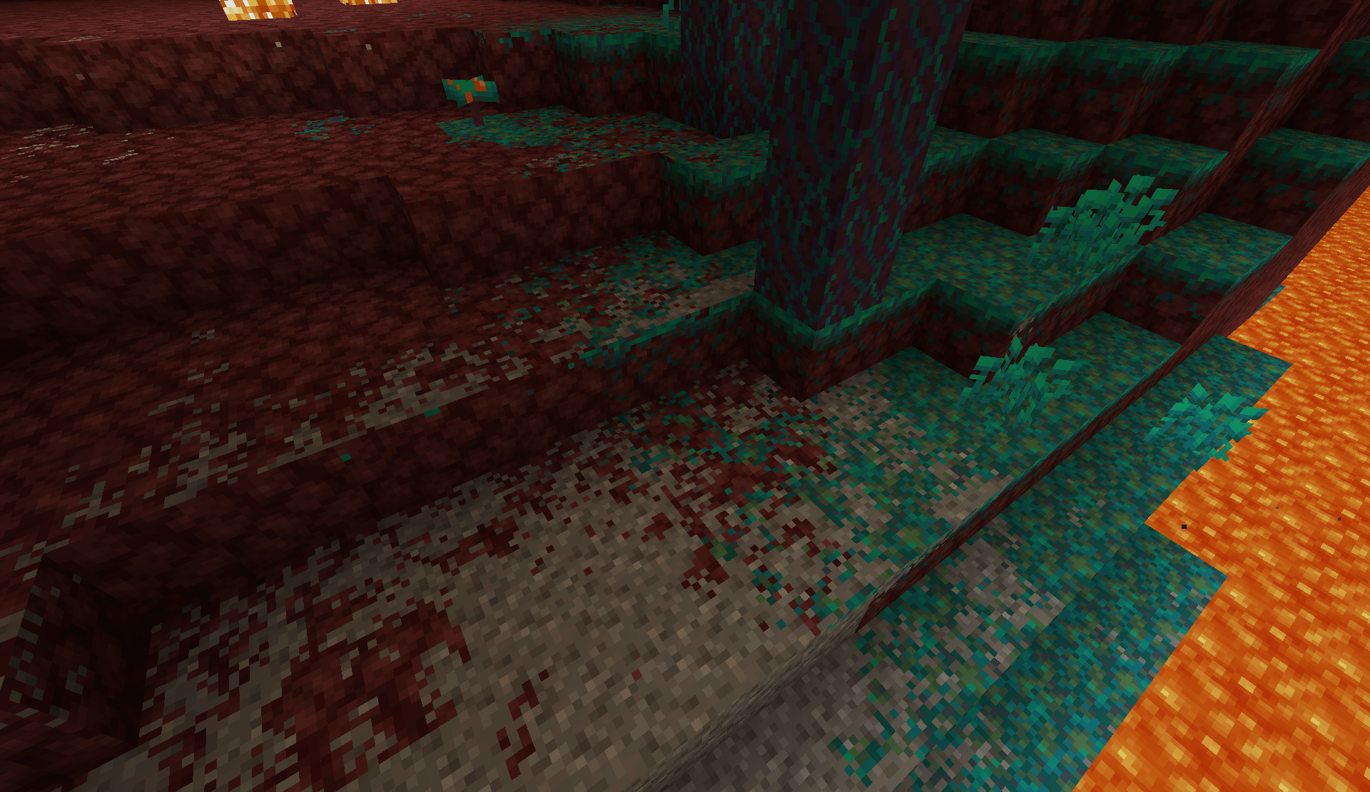 Warped terrain blending into netherrack beside a Nether lava lake