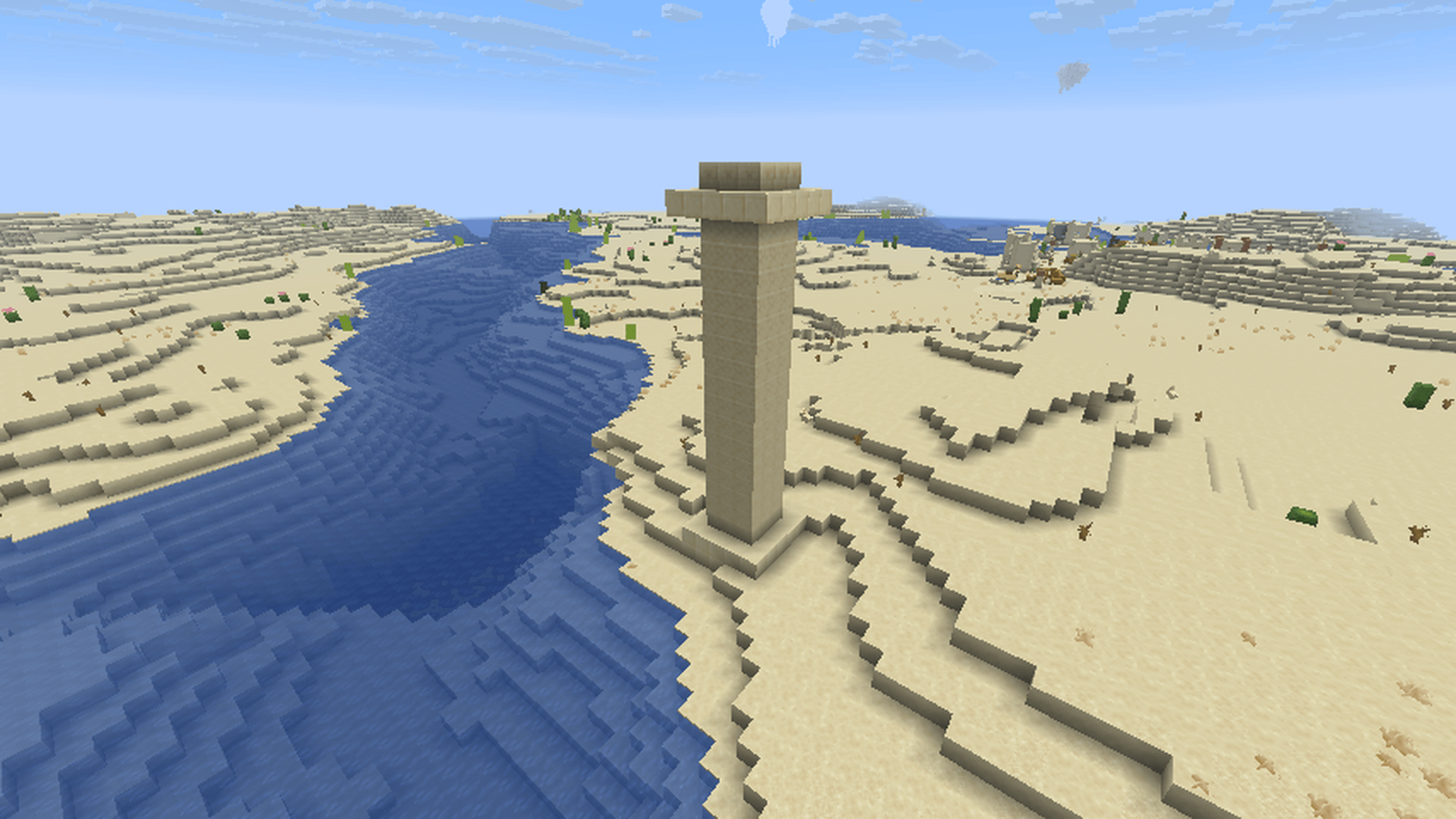 Thumbnail A sandstone pillar standing over a desert river.