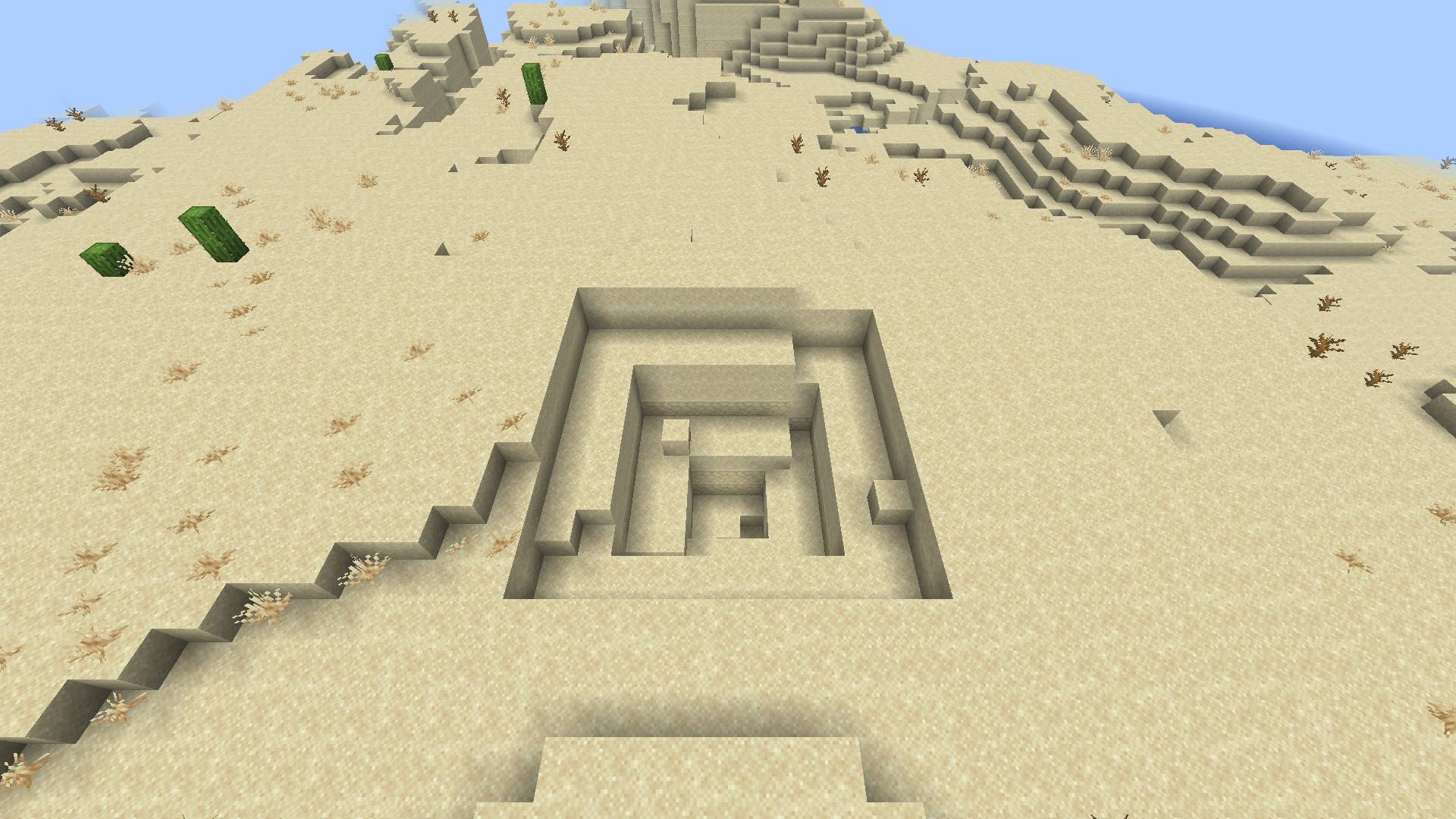 Thumbnail A sand pit stepping down into the desert.