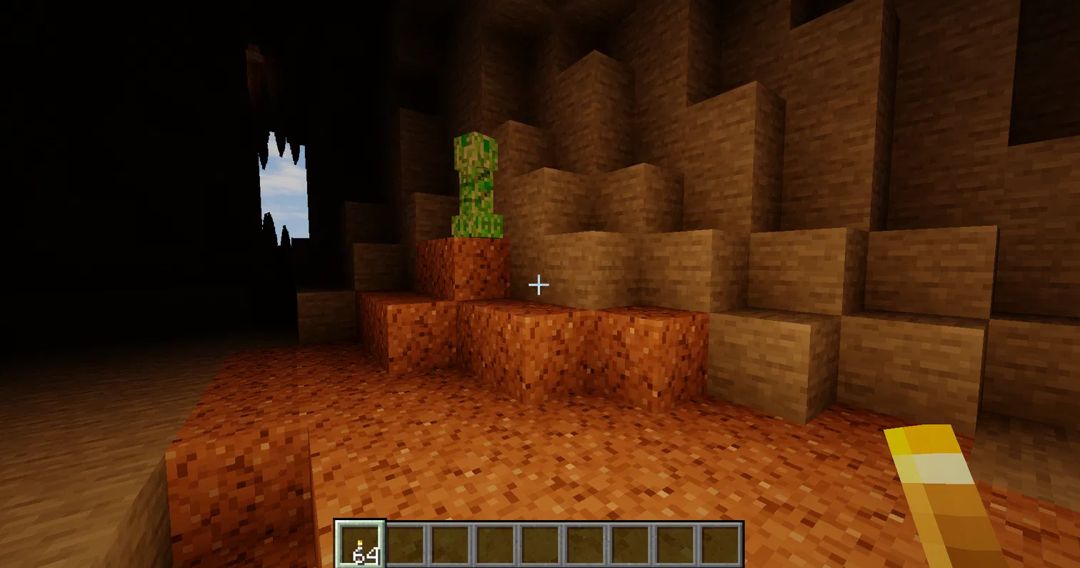 Thumbnail A torch in your hand lights the cave with warm orange light and soft shadows.