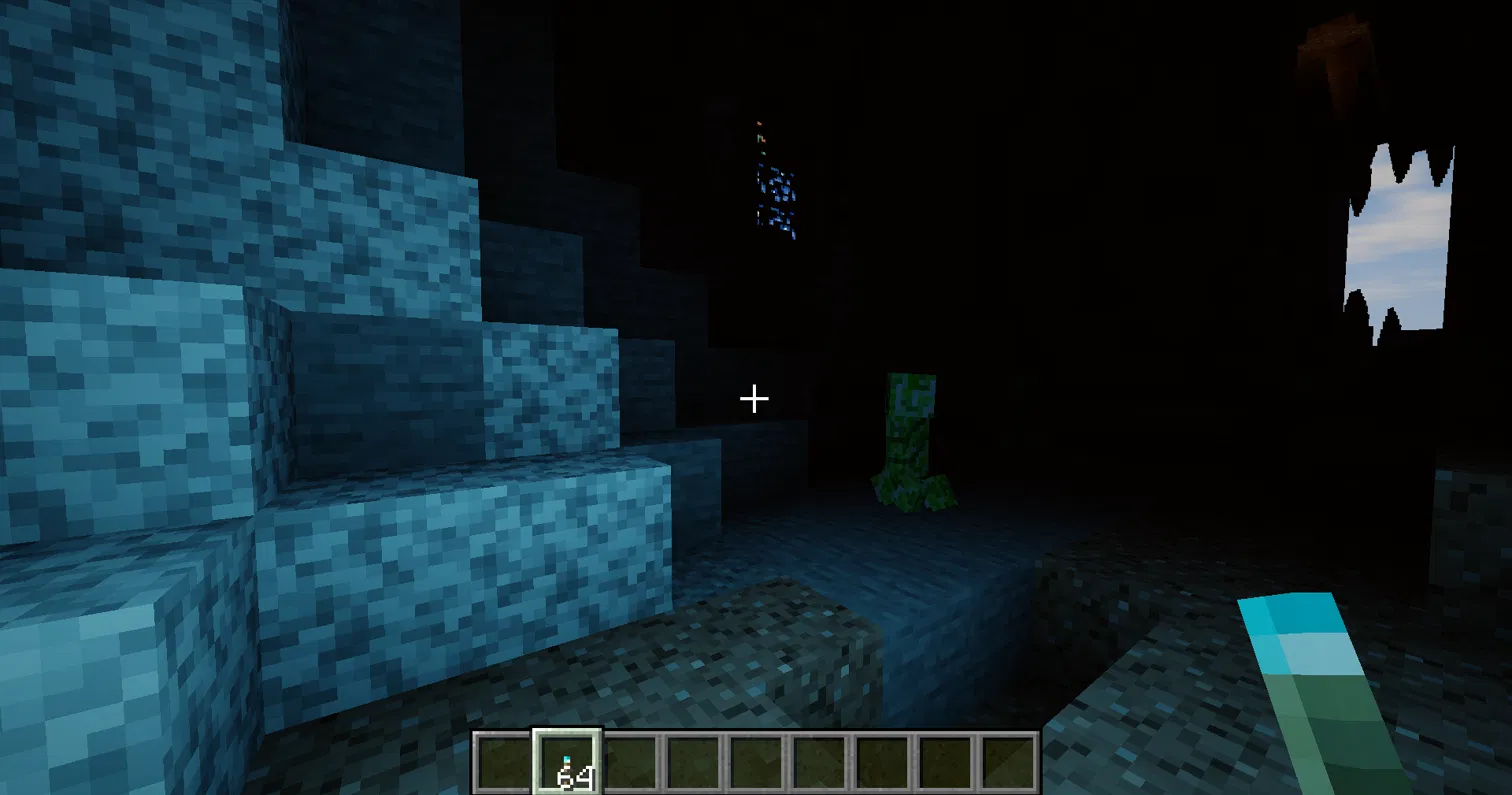 Thumbnail The light you hold changes colour. A soul torch fills the cave with cool blue light.