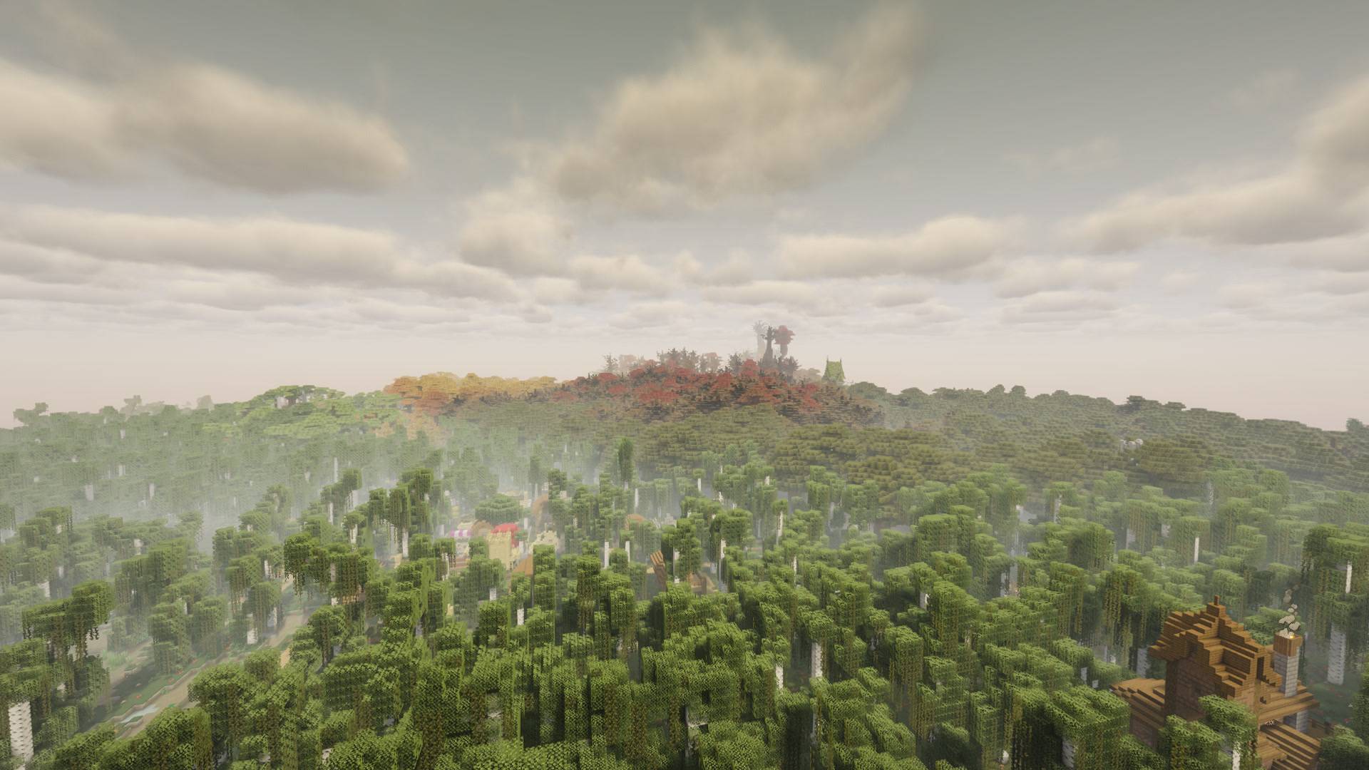 Development preview: dense forest surrounds scattered buildings beneath a hazy sky.