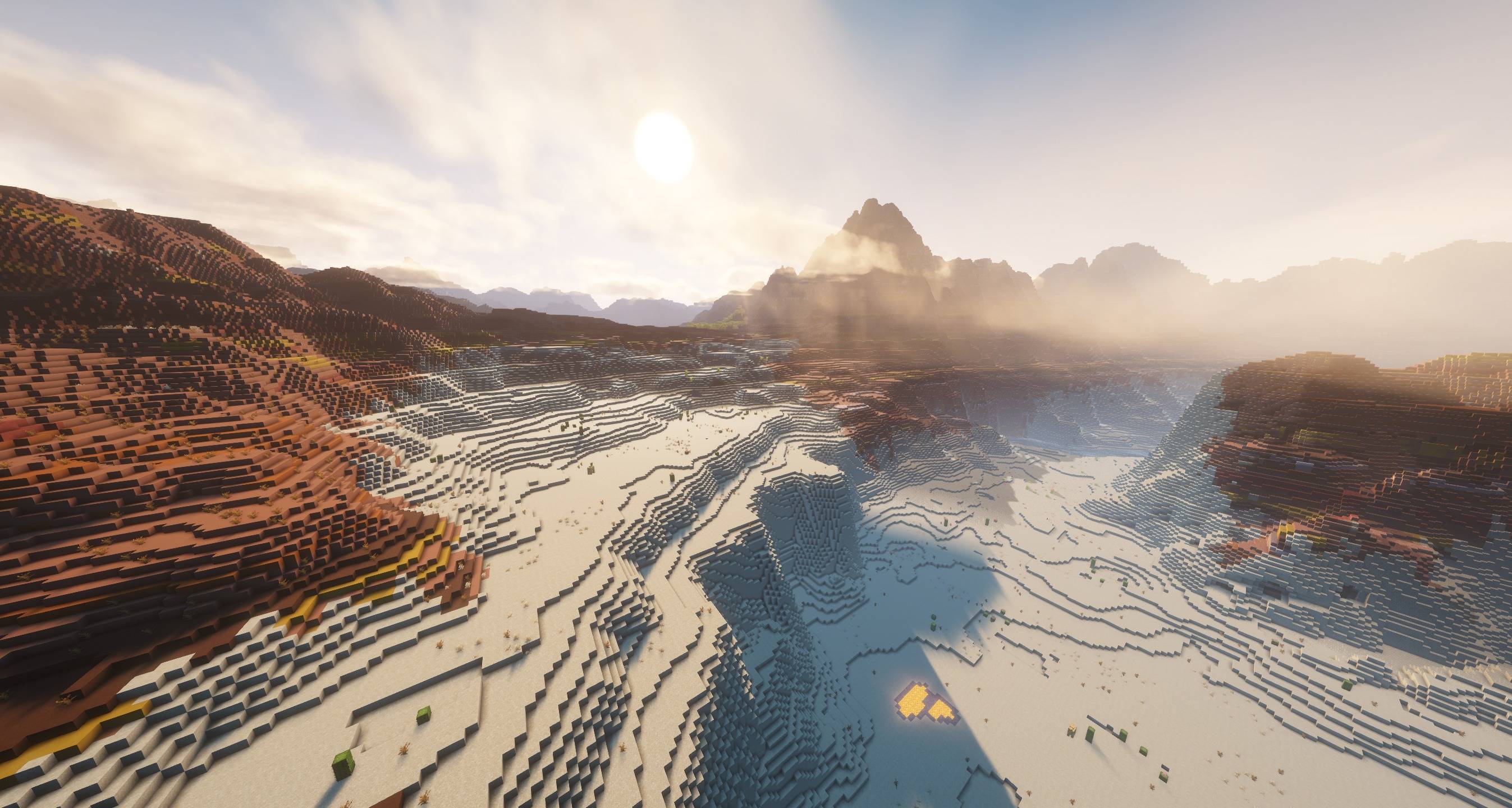 Thumbnail Morning light over a desert and badlands valley, with dynamic clouds around the mountain ridge. Minecraft 26.3 in-game capture.