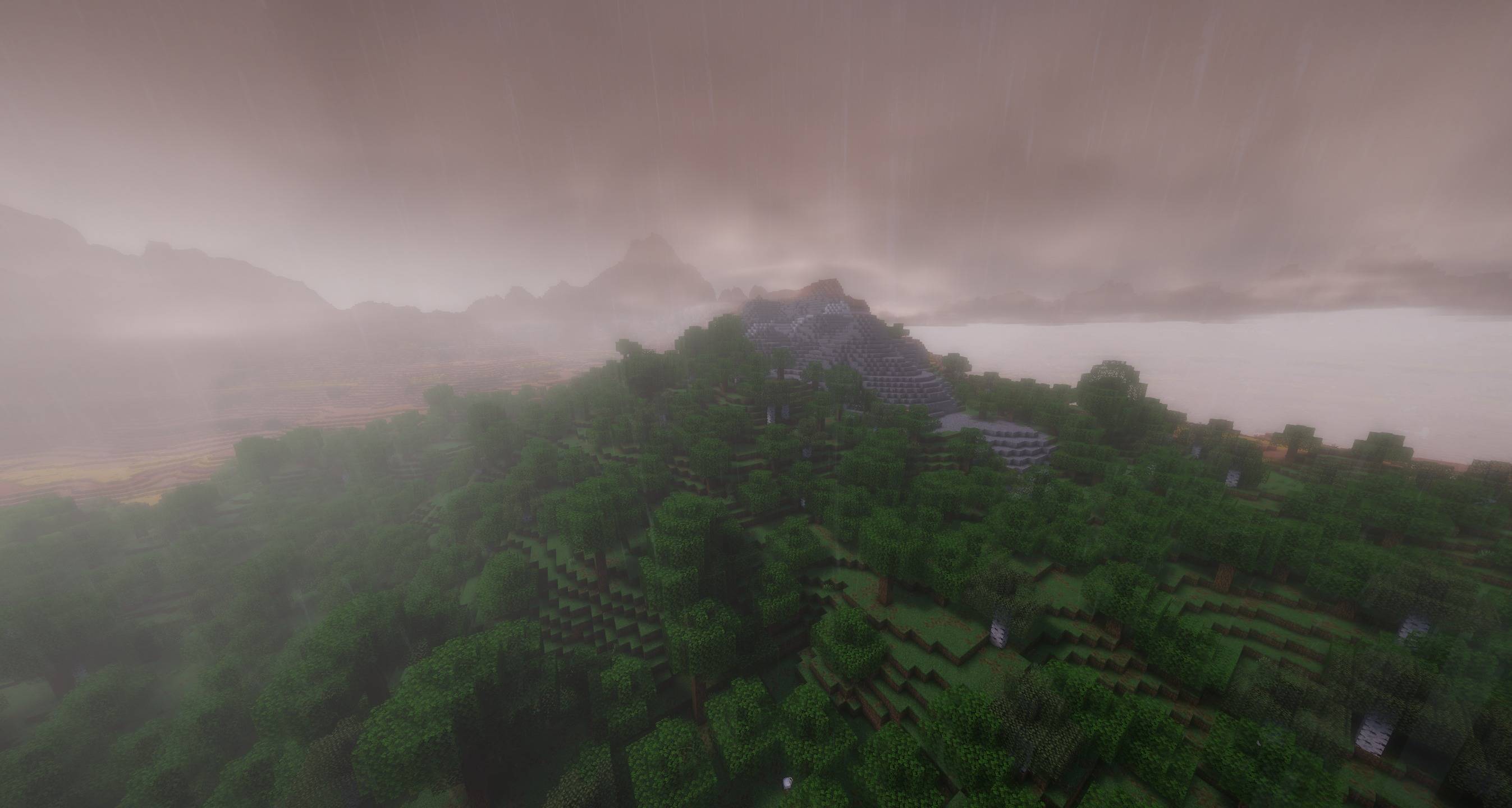 Thumbnail Rain and low clouds soften the light over forested hills. Cinematic Drift in Minecraft 26.3.