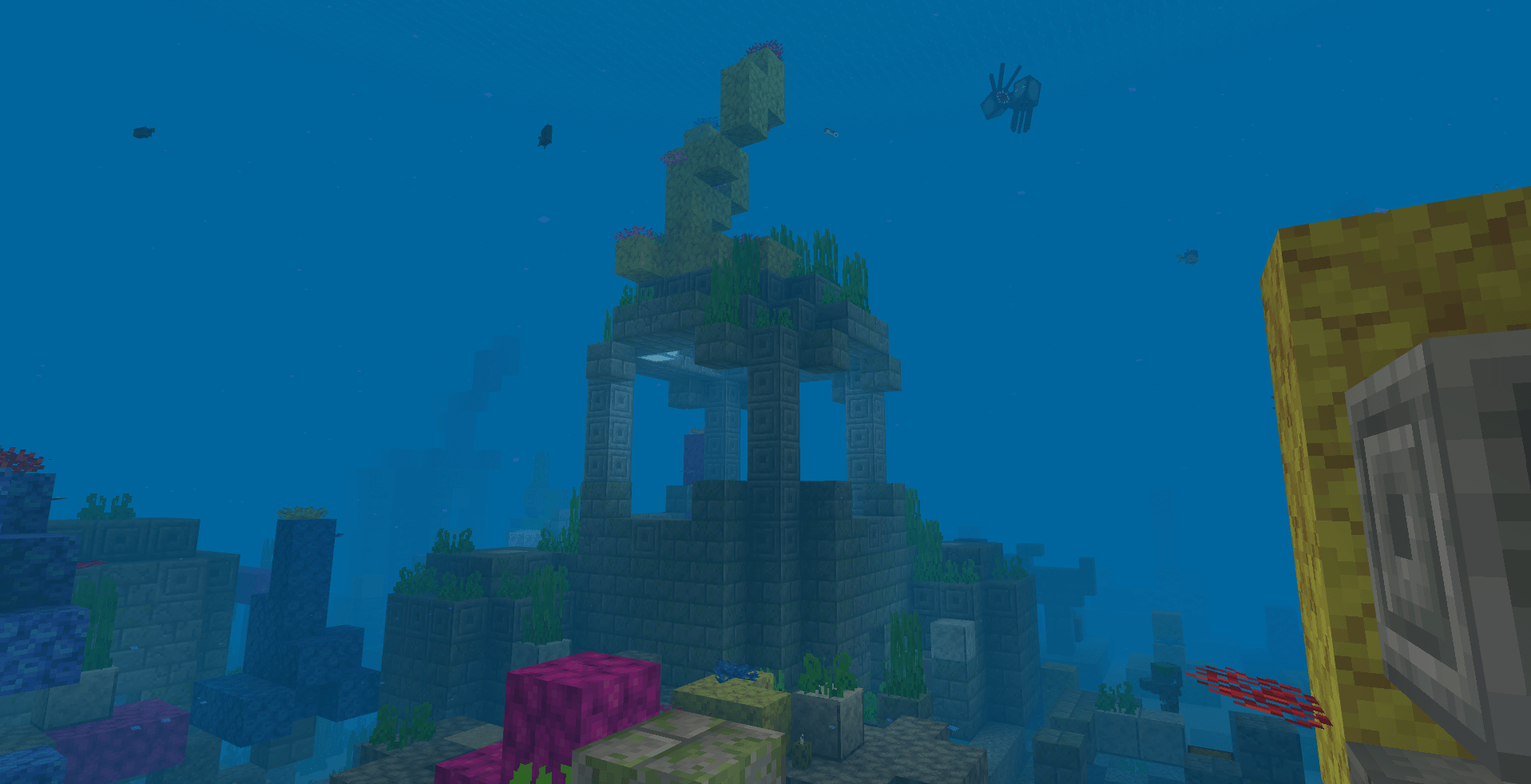 A stone tower surrounded by coral.
