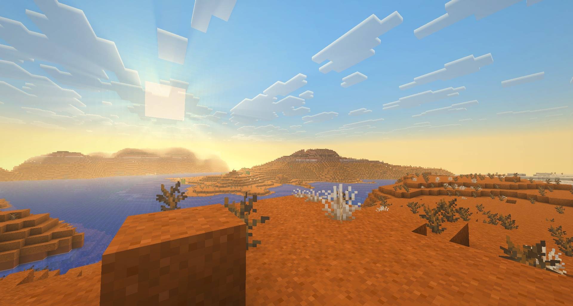 Dusty haze over badlands at sunset