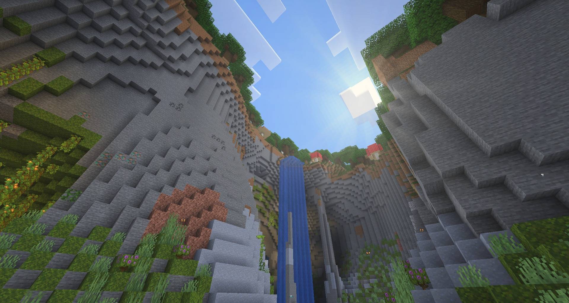 Sunlight pouring into a ravine with a waterfall