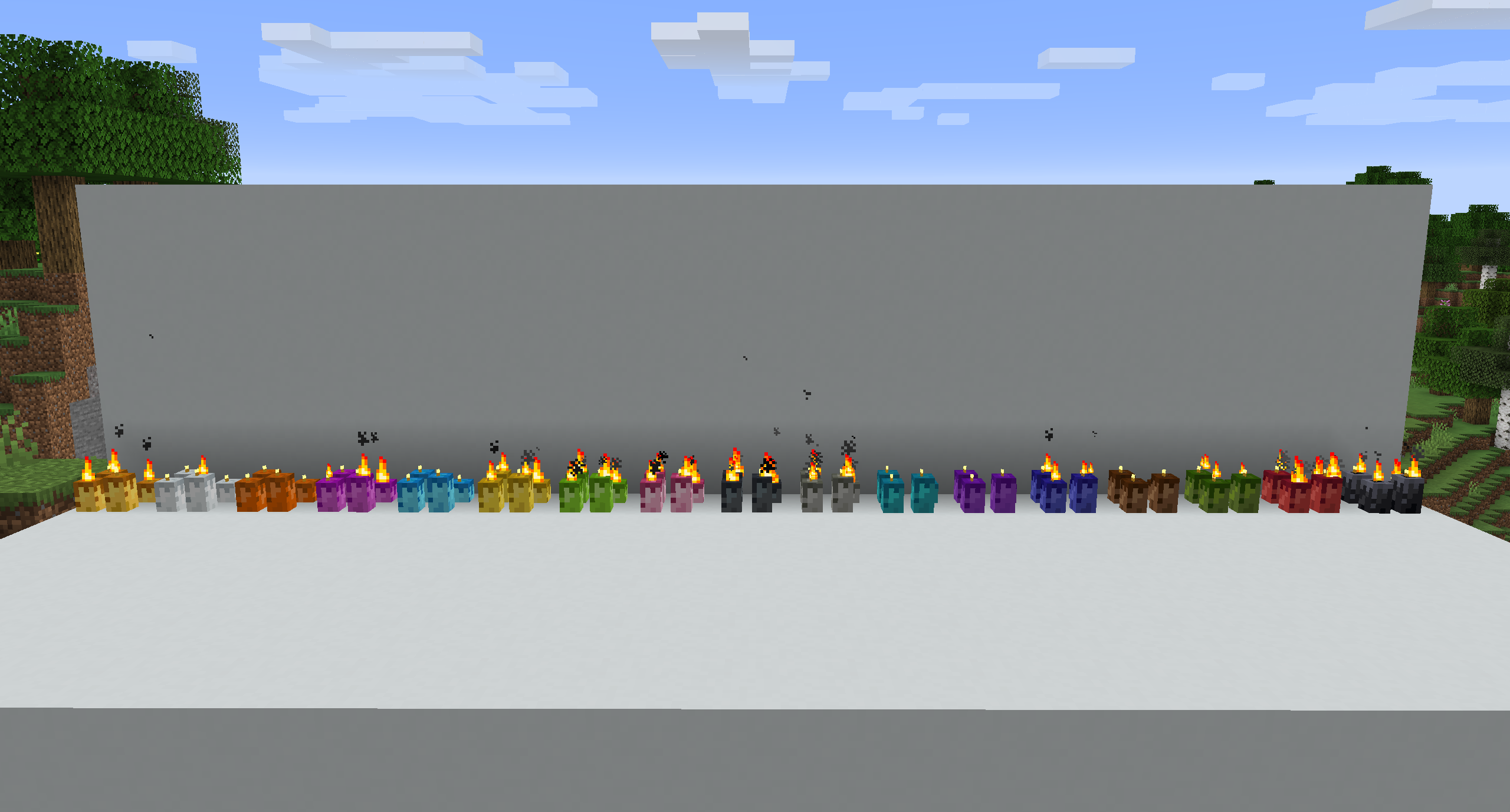 All colour variants of the candles. From left to right: beeswax, white, orange, magenta, light blue, yellow, lime, pink, grey, light grey, cyan, purple, blue, brown, green, red, black.