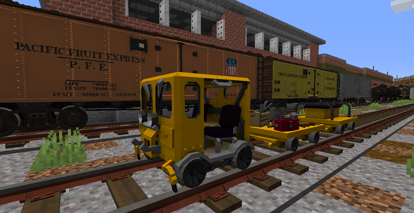 Speeder train sitting in front of a string of reefer cars