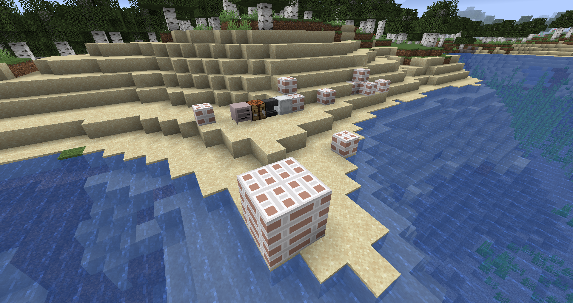A lot of packages, a transport hub, a shulker box, an anvil, and a crafting table all on a beach