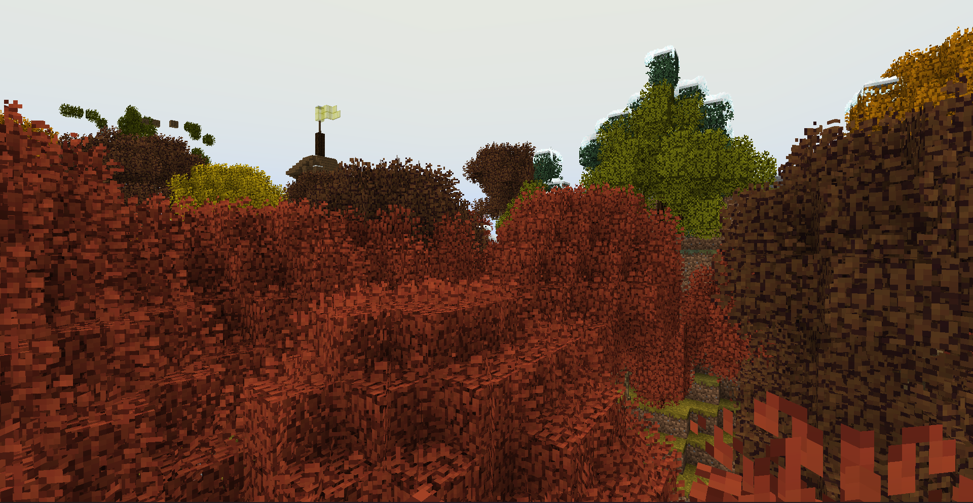 Random snow topped trees with a tower in the distance.