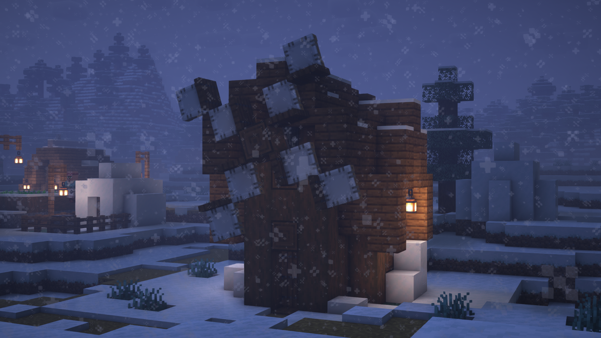 A windmill in a snowy village.