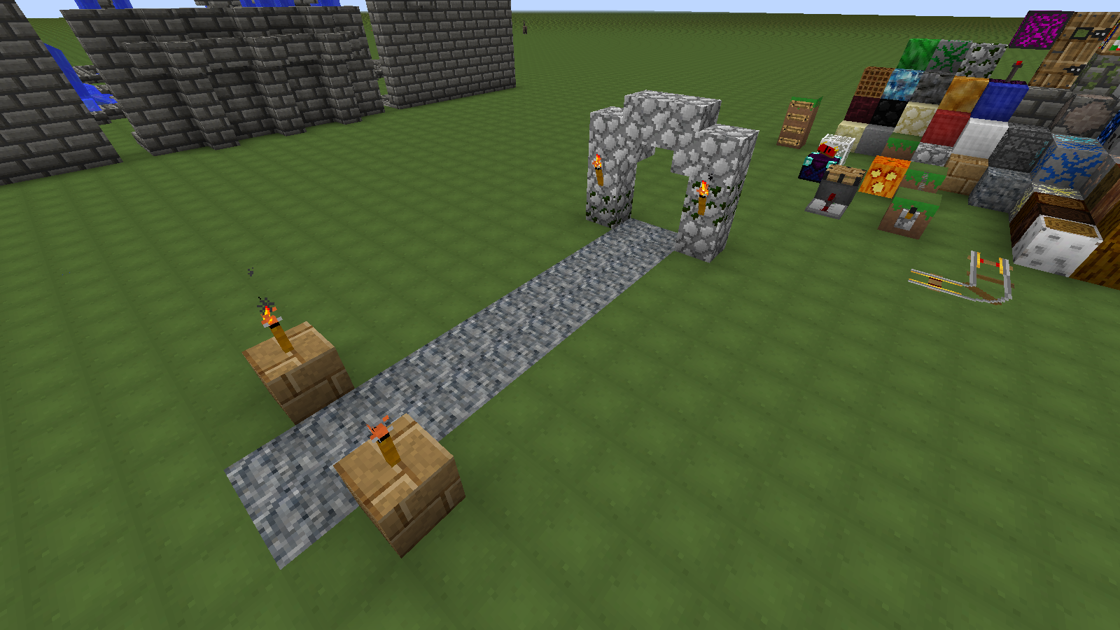 Here is what a gravel path may look like, with cobblestone arch and oak wood plank torch stands.