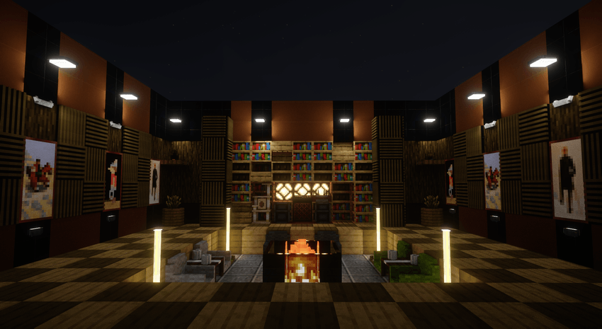 A Minecraft screenshot of a modern, symmetrical indoor music lounge with an open ceiling revealing a starry night sky. In the center is a sunken seating area with armchairs around a glowing fireplace. The back wall features a large arrangement of colourful bookshelves, with an audio mixer, speakers and disc holder placed in front of redstone lamps. The side walls are decorated with paintings between Cozy walls (to absorb sound) and are illuminated by wall lights and tall glowing RGB floor lamps.