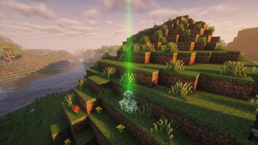 A raid crystal and its green beam on a grassy hill