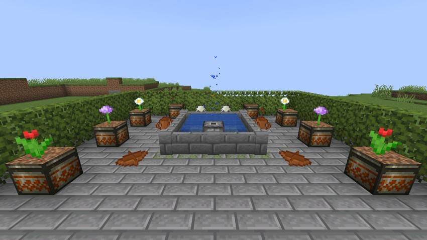 A garden with the fountain spraying in its pool, planter pots full of flowers and clay and bone decorations