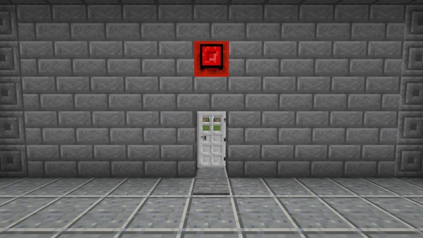 An alarm box over a door, wired to a pressure plate in front of it