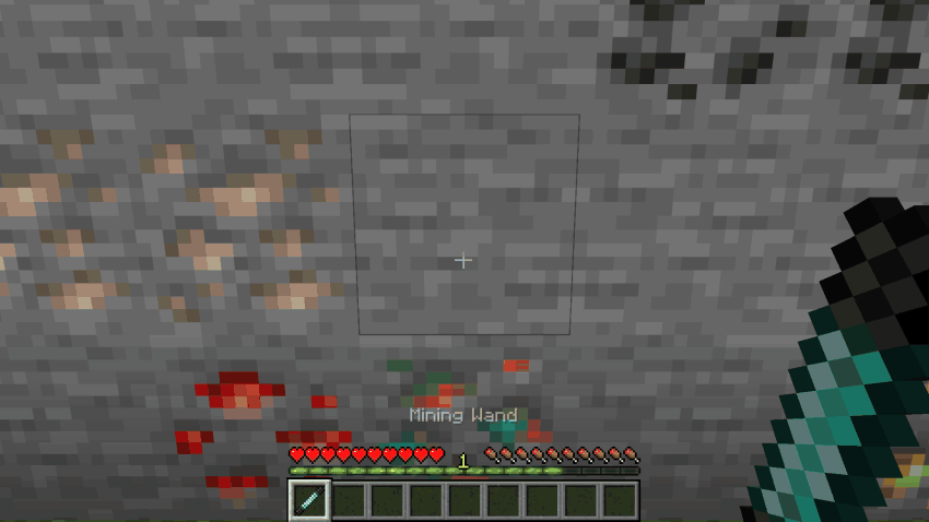 A Mining Wand clicked on two corners of a block of stone and ore, which is mined and drops all of it