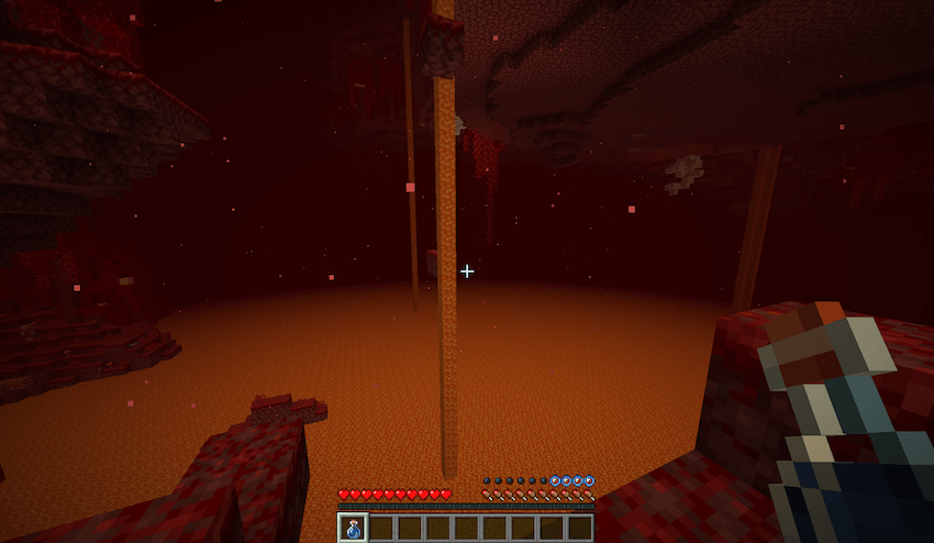 A Minecraft player standing at the edge of a lava lake inside the Nether dimension, holding a water bottle with only four oxygen bubbles remaining above the hunger bar, showing the underwater breathing challenge.
