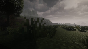 Blocky grassland fades into fog beneath heavy clouds, with dim light washing over the terrain.