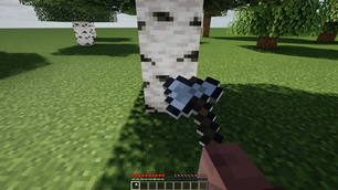 The axe bites into the trunk