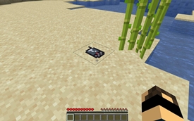 A mobile phone left on the sand.
