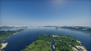 A wide river between wooded shores