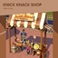 Knick Knack Shop Stall By NerdyDoll Spanish Translation logo