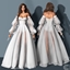Wedding Dress with Sheer Puff Sleeves and Satin Corset logo