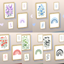 Paintings, rainbow, flowers, branches, and unintelligible writing logo